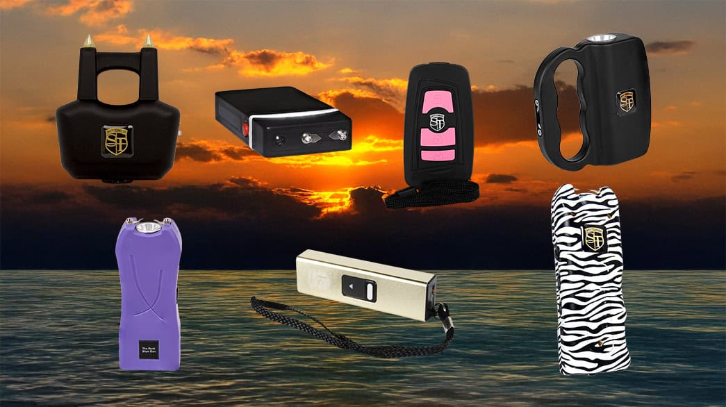 Various models of self-defense stun guns with sunset ocean background.