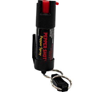 Compact black pepper spray with keychain attachment for self-defense.