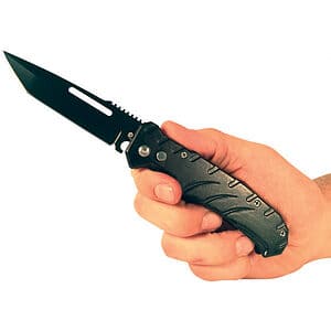 Hand holding a black folding knife with textured grip, open blade visible.