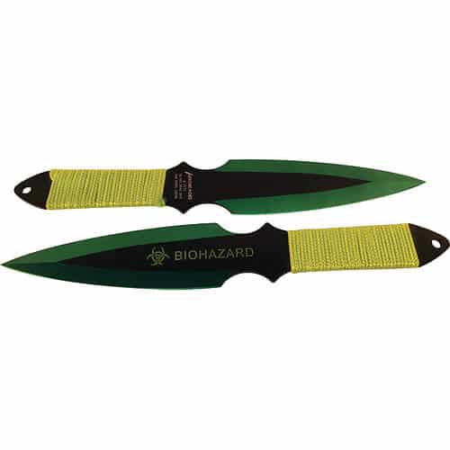 Two biohazard-themed throwing knives with green and black blades, yellow cord-wrapped handles.