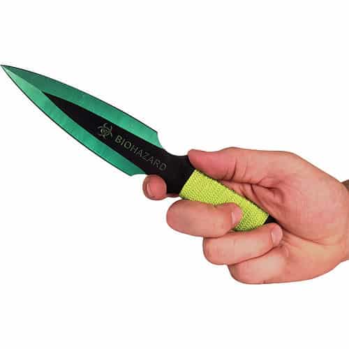 Hand holding a green Biohazard knife with a textured grip.