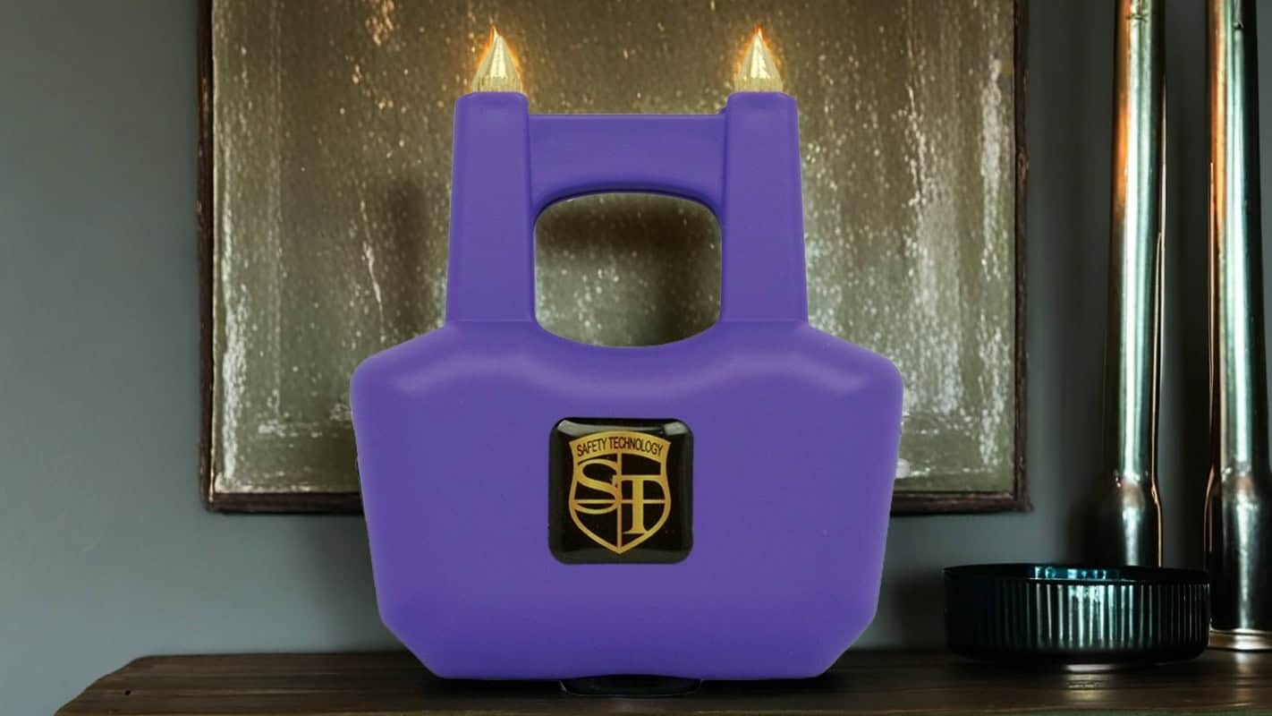 Purple safety device with pointed tips and logo on display shelf.